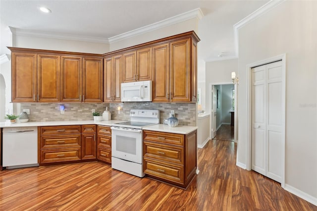 15324 Sherwood Forest Dr, Tampa, FL 33647 - kitchen featuring white appliances, brown cabinetry, and ornamental molding