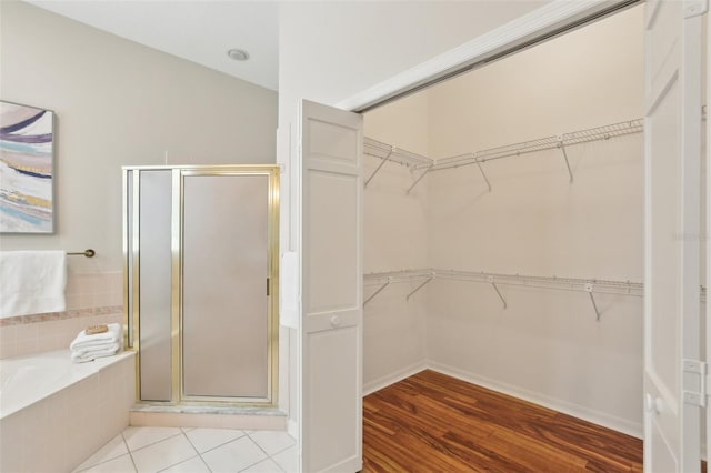 15324 Sherwood Forest Dr, Tampa, FL 33647 - bathroom featuring a shower stall, a bath, a spacious closet, and wood finished floors