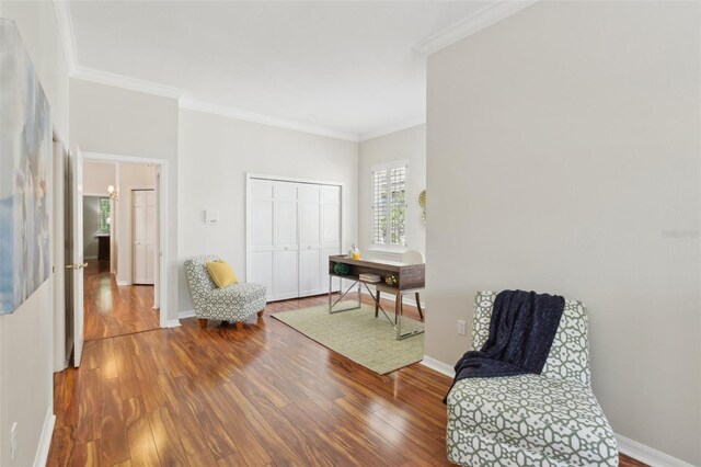 15324 Sherwood Forest Dr, Tampa, FL 33647 - sitting room featuring wood finished floors, ornamental molding, and baseboards