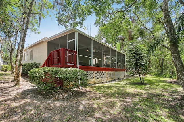 15324 Sherwood Forest Dr, Tampa, FL 33647 - rear view of house featuring a sunroom and stucco siding