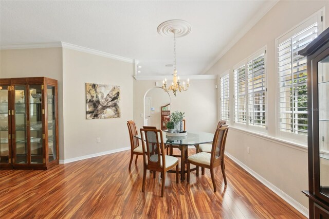 15324 Sherwood Forest Dr, Tampa, FL 33647 - dining room with crown molding, wood finished floors, baseboards, and a chandelier