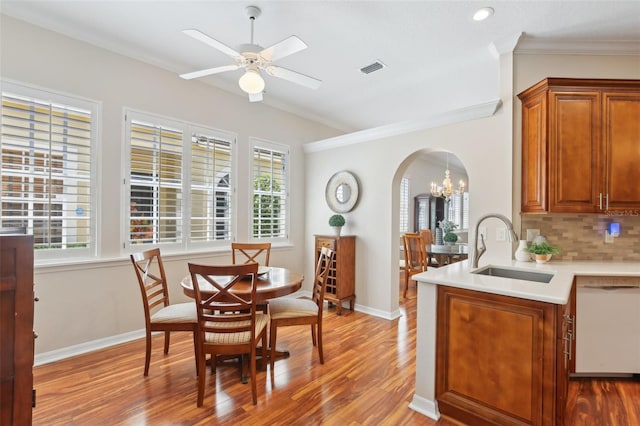 15324 Sherwood Forest Dr, Tampa, FL 33647 - dining space with arched walkways, crown molding, wood finished floors, healthy amount of natural light, and a ceiling fan