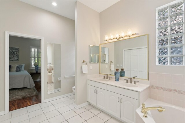15324 Sherwood Forest Dr, Tampa, FL 33647 - bathroom with ensuite bath, toilet, tile patterned flooring, a bath, and double vanity
