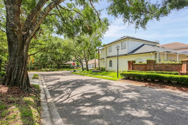 15324 Sherwood Forest Dr, Tampa, FL 33647 - view of side of home featuring driveway and stucco siding