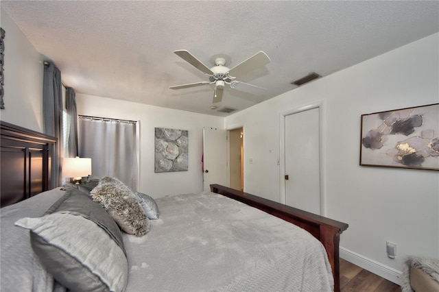 12532 115th St, Largo, FL 33778 - bedroom with wood finished floors, visible vents, ceiling fan, and baseboards