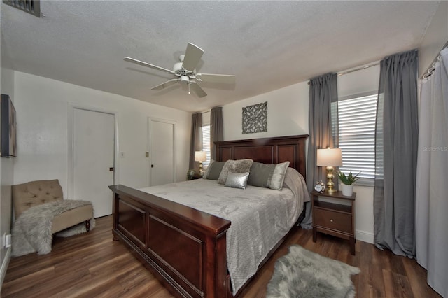12532 115th St, Largo, FL 33778 - bedroom with a ceiling fan, dark wood-style flooring, and visible vents