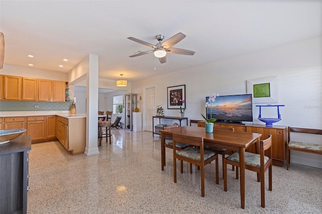 dining space with a ceiling fan, baseboards, light speckled floor, and recessed lighting