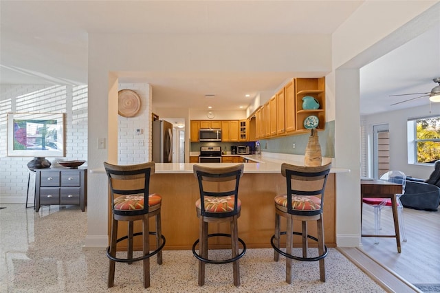 kitchen featuring stainless steel appliances, open shelves, light countertops, baseboards, and ceiling fan