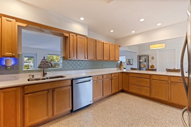 kitchen featuring a sink, stainless steel appliances, light countertops, backsplash, and recessed lighting