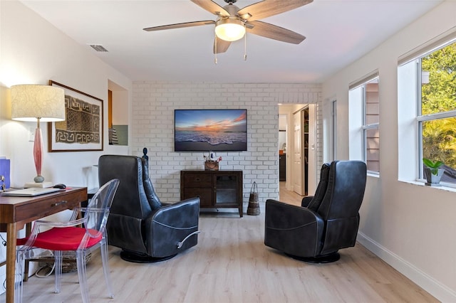 living room with visible vents, baseboards, wood finished floors, and ceiling fan