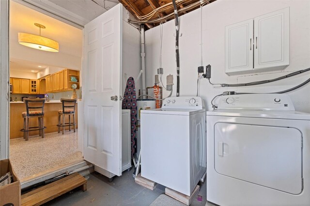 laundry room featuring washer and clothes dryer and cabinet space