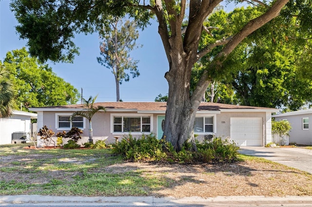 ranch-style home with an attached garage, driveway, and stucco siding