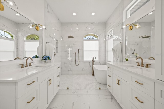 bathroom featuring marble finish floor, a sink, and a marble finish shower
