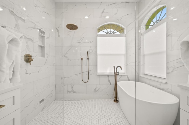 full bathroom featuring tile walls, a freestanding tub, and a walk in shower