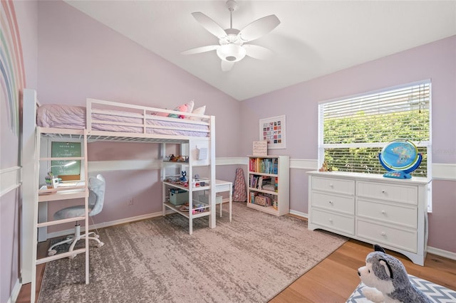 bedroom featuring baseboards, lofted ceiling, ceiling fan, and wood finished floors