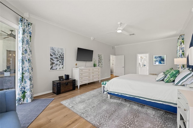 bedroom with wood finished floors, baseboards, and ornamental molding