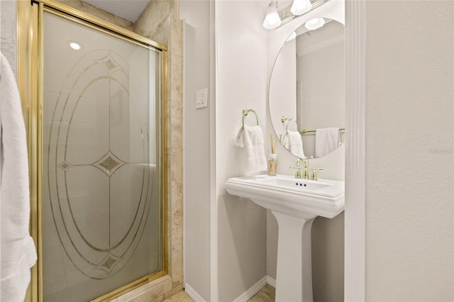 full bath with a shower stall and baseboards