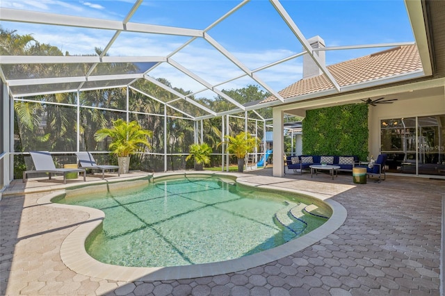 outdoor pool featuring a lanai, an outdoor living space, a ceiling fan, and a patio