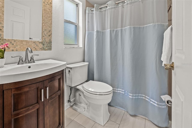 bathroom with toilet, tile patterned floors, vanity, and curtained shower