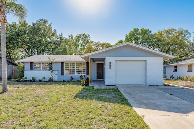 10137 Oleander Dr, Port Richey, FL 34668 - single story home featuring concrete driveway, a front lawn, a garage, and brick siding