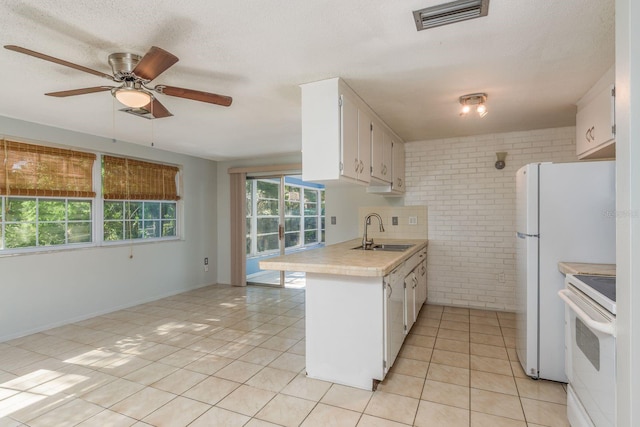 10137 Oleander Dr, Port Richey, FL 34668 - kitchen featuring white electric range, a sink, brick wall, light countertops, and ceiling fan