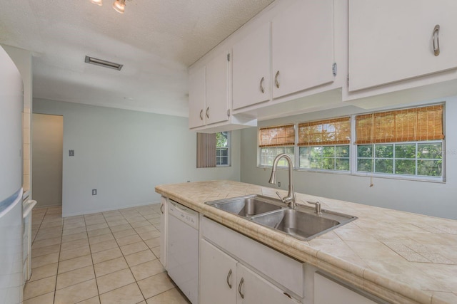 10137 Oleander Dr, Port Richey, FL 34668 - kitchen with white appliances, a sink, tile countertops, white cabinetry, and light tile patterned flooring