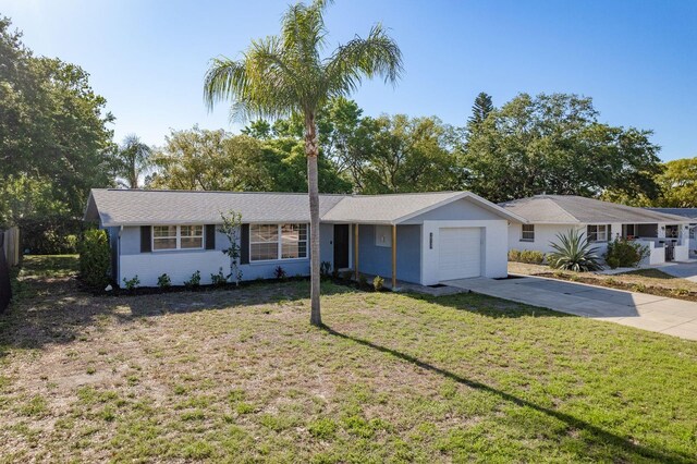 10137 Oleander Dr, Port Richey, FL 34668 - ranch-style house with a garage, driveway, a front lawn, and stucco siding