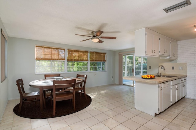 10137 Oleander Dr, Port Richey, FL 34668 - kitchen featuring a sink, white dishwasher, light countertops, white cabinets, and ceiling fan