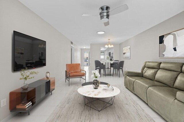 500 Glennes Ln Unit 205, Dunedin, FL 34698 - living area with ceiling fan with notable chandelier, baseboards, and light tile patterned flooring