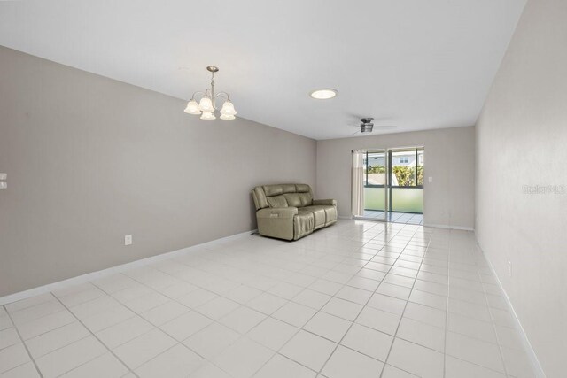 500 Glennes Ln Unit 205, Dunedin, FL 34698 - unfurnished living room featuring a chandelier and baseboards