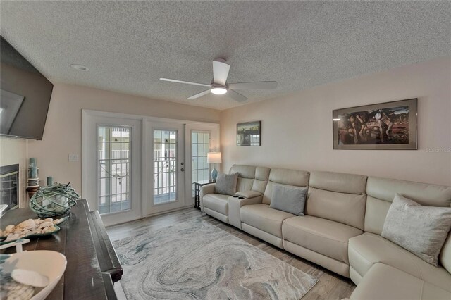 17960 Gulf Blvd Unit 111, Redington Shores, FL 33708 - living area featuring a ceiling fan, a textured ceiling, and wood finished floors