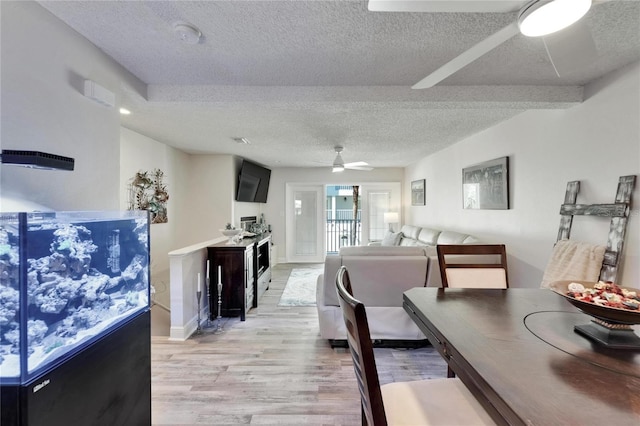 17960 Gulf Blvd Unit 111, Redington Shores, FL 33708 - dining space with ceiling fan, light wood-style flooring, and a textured ceiling