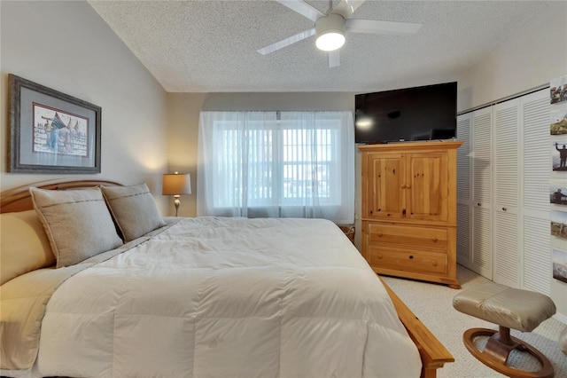 17960 Gulf Blvd Unit 111, Redington Shores, FL 33708 - bedroom featuring ceiling fan, a closet, a textured ceiling, and light colored carpet
