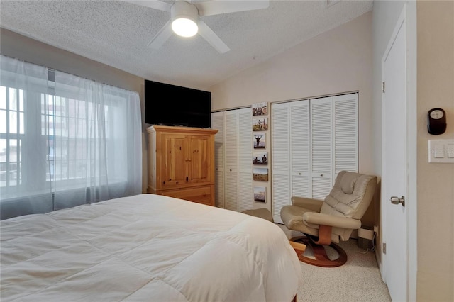 17960 Gulf Blvd Unit 111, Redington Shores, FL 33708 - carpeted bedroom featuring multiple closets, ceiling fan, a textured ceiling, and lofted ceiling