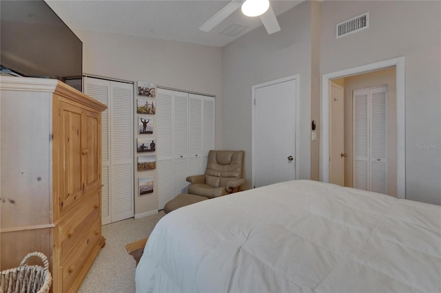 17960 Gulf Blvd Unit 111, Redington Shores, FL 33708 - carpeted bedroom with visible vents, a ceiling fan, and two closets