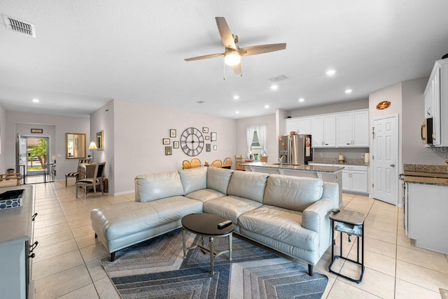 living room with light tile patterned floors, ceiling fan, recessed lighting, and visible vents