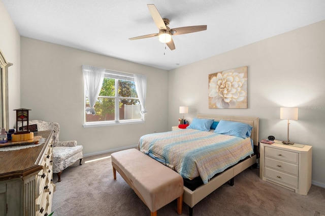 carpeted bedroom featuring baseboards and ceiling fan