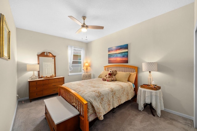 bedroom with light colored carpet, a ceiling fan, and baseboards