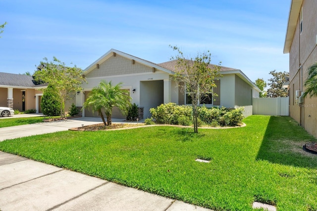 ranch-style home featuring fence, a garage, stucco siding, a front yard, and driveway