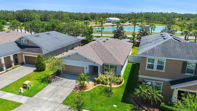 drone / aerial view featuring a water view and a residential view