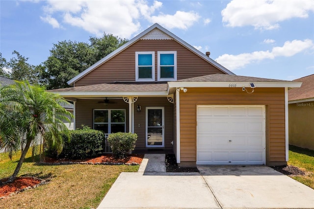 view of front of property with covered porch, a front yard, roof with shingles, an attached garage, and driveway
