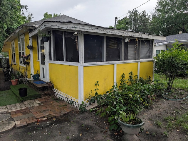 730 Citrus St, Orlando, FL 32805 - view of property exterior with a sunroom and a shingled roof