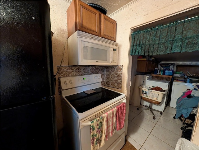730 Citrus St, Orlando, FL 32805 - kitchen with white appliances, brown cabinets, light tile patterned flooring, washing machine and dryer, and decorative backsplash