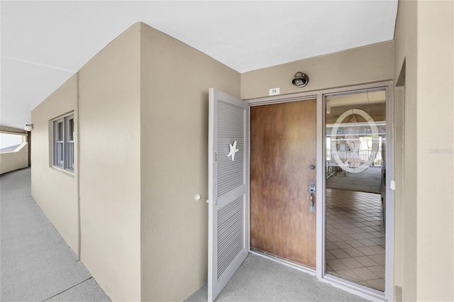 4450 Gulf Blvd Unit 114, St Pete Beach, FL 33706 - view of exterior entry with stucco siding