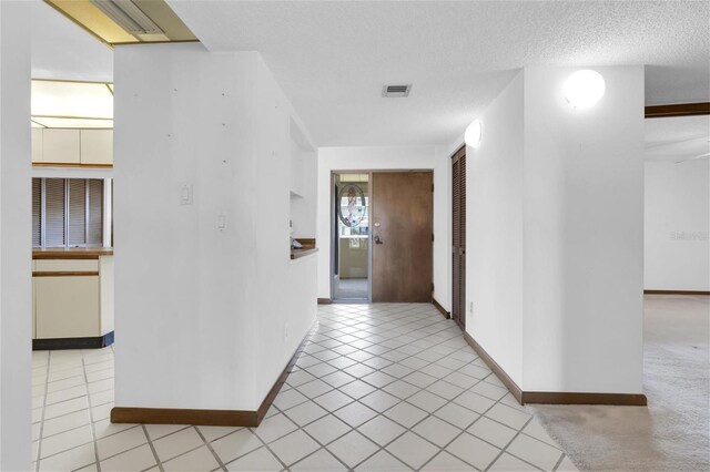 4450 Gulf Blvd Unit 114, St Pete Beach, FL 33706 - corridor featuring light tile patterned floors