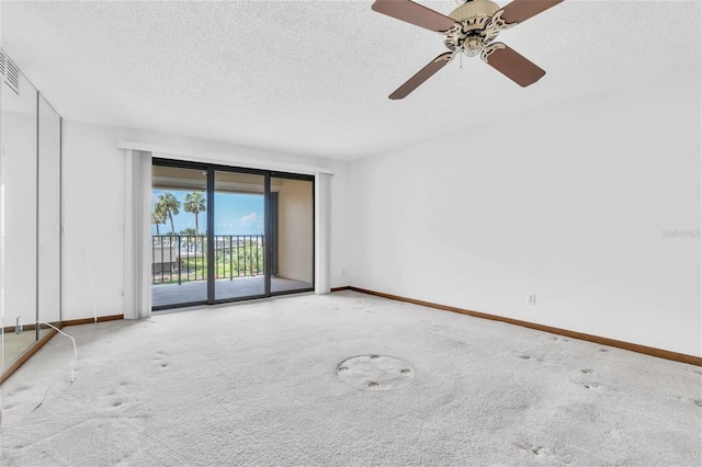 4450 Gulf Blvd Unit 114, St Pete Beach, FL 33706 - carpeted spare room with a textured ceiling and a ceiling fan