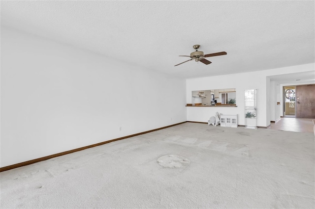 4450 Gulf Blvd Unit 114, St Pete Beach, FL 33706 - unfurnished living room featuring carpet, ceiling fan, and a textured ceiling