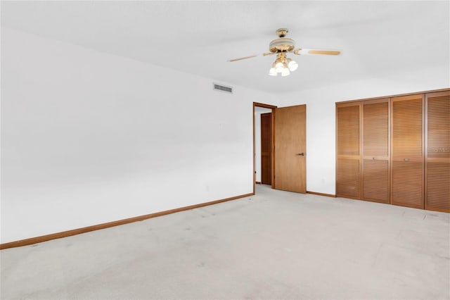 4450 Gulf Blvd Unit 114, St Pete Beach, FL 33706 - unfurnished bedroom with light colored carpet, a closet, and a ceiling fan