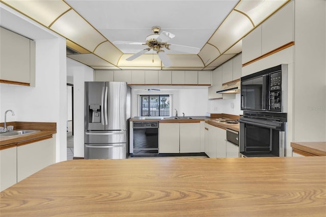 4450 Gulf Blvd Unit 114, St Pete Beach, FL 33706 - kitchen featuring black appliances, under cabinet range hood, ceiling fan, and white cabinets