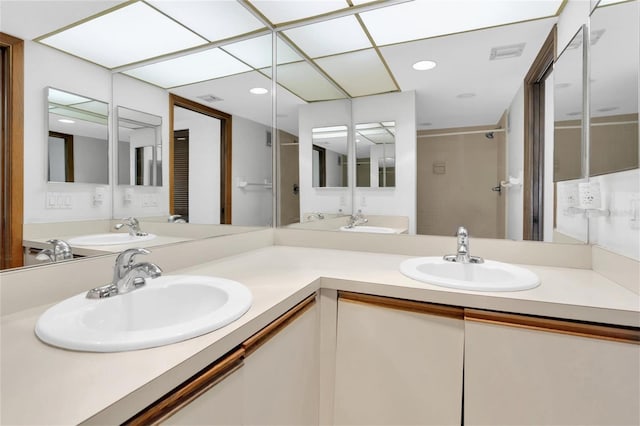 4450 Gulf Blvd Unit 114, St Pete Beach, FL 33706 - bathroom featuring double vanity and recessed lighting